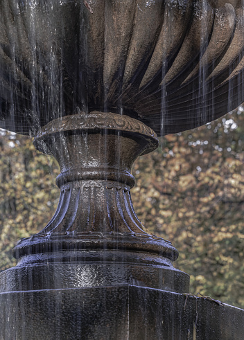 Close-up of The tiered water fountain statues in Regentâs park. which creates aesthetic atmosphere, Classic style stone fountain with flowing water, Vintage fountain, Space for text, Selective Focus.