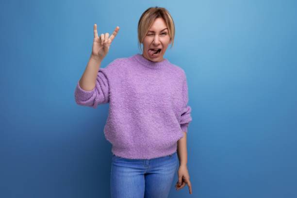 istock adorable energetic pleasant blond young woman with a grimace on a bright plain background 1799395434