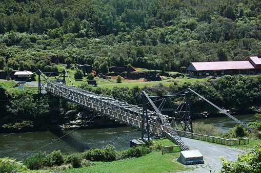 historic swing bridge over Grey river at Brunner Coal Mine, West Coast, New Zealand