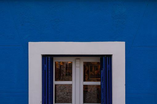 vintage window on a blue wall, exterior design frame