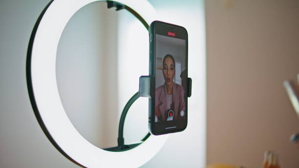 istock Makeup artist talking cellphone screen home closeup. Blogger recommend cosmetics 1799464569