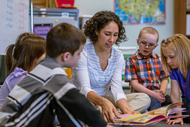 istock Young teacher reads with her students in the classroom 1799467345