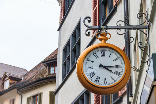 Close-up of big clock on the building in Switzerland