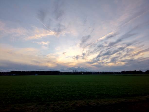 istock Dutch November Evening: Sunset Casting Glow Over Farm Fields 1799477927