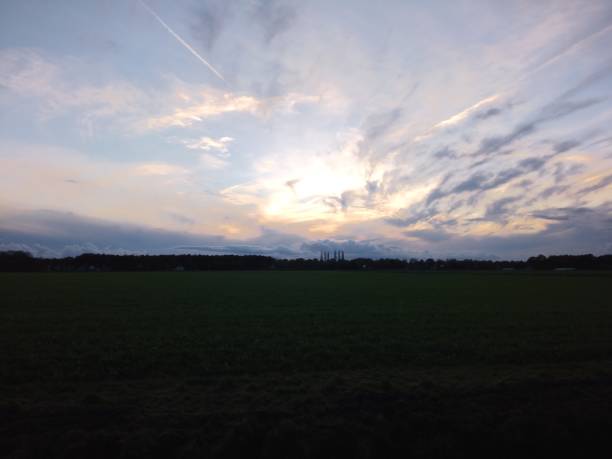 istock Dutch November Evening: Sunset Casting Glow Over Farm Fields 1799483811