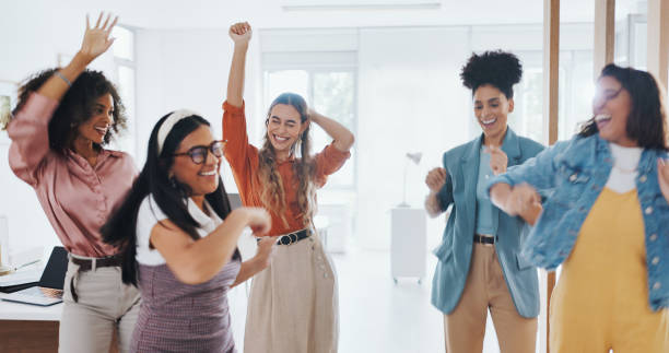 istock Business people, happiness and dance in office at work for celebration, target and team building with energy. Employees, success and marketing with excited women for growth, start up and career 1799503759