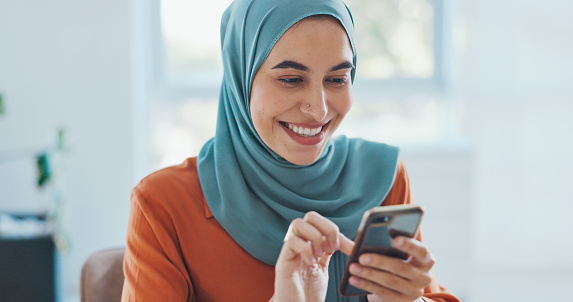 Muslim, woman and scroll social media with smartphone for communication with technology and happy in hijab at workplace. Islamic worker, social network and mobile phone app notification with wifi.