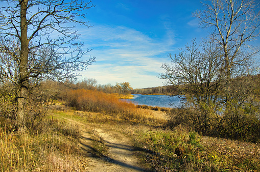 Late Autumn Landscape of The Ice Age Trail passing beside a forest lake on a sunny day in Wisconsin.