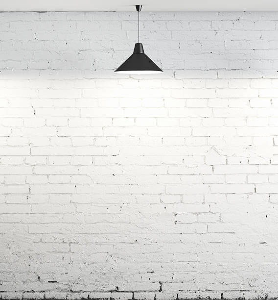 istock White brick wall illuminated by the lamp 179959529