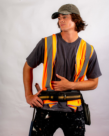 Good looking young builder apprentice gears up for a job.