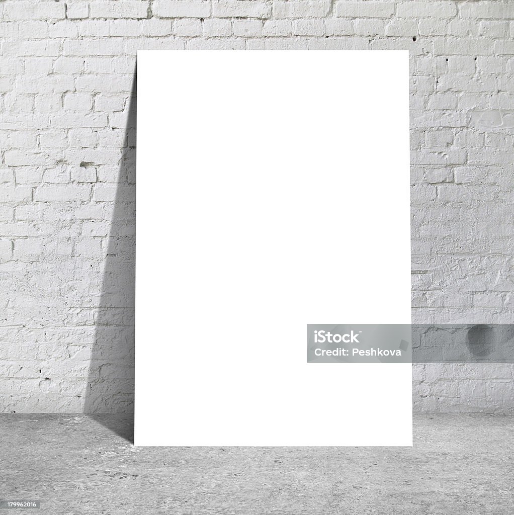 white table table standing next to a brick wall Indoors Stock Photo