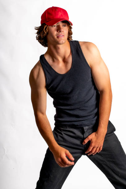 istock good looking young man prepares to go surfing. 1799620532