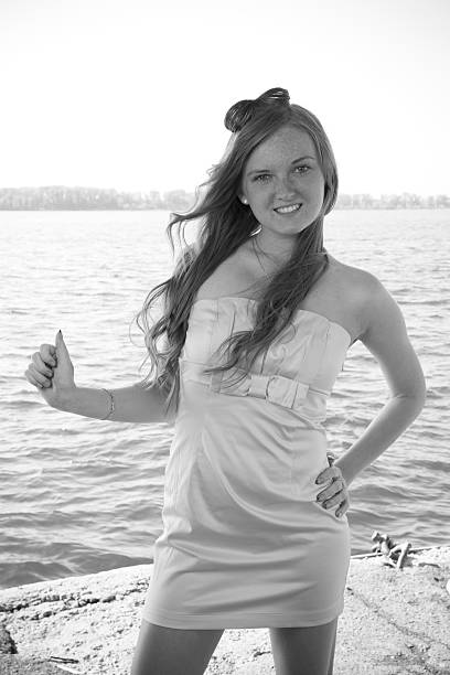 Beautiful young woman on a background of the river. Professional hairstyle.