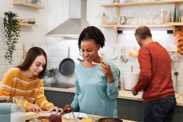 istock Cheerful family making breakfast in a domestic kitchen 1799641491