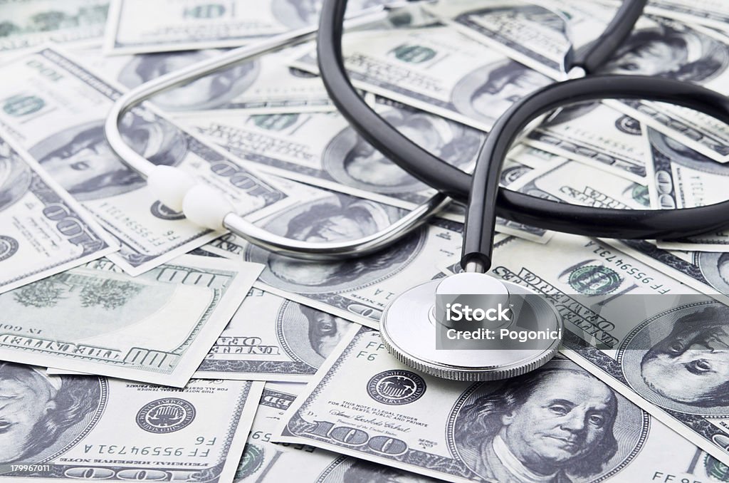 Health care costs Stethoscope and money symbol for health care costs or medical insurance Accidents and Disasters Stock Photo