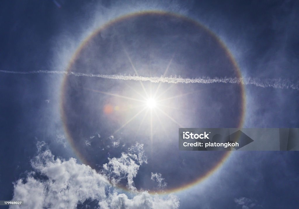 beautiful sun halo phenomenon Sun with circular rainbow - sun halo occurring due to ice crystals in atmosphere Blue Stock Photo