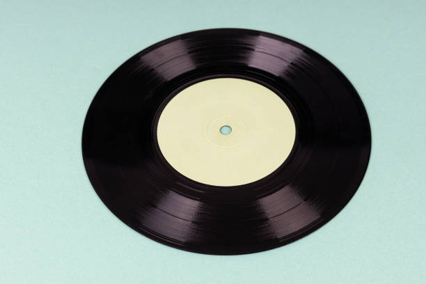 istock Old vinyl disc on green background. Old vintage vinyl record. 1799727928