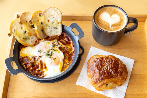 A Hearty Japanese Breakfast with Shakshuka, Croissant, and a Cup of Coffee