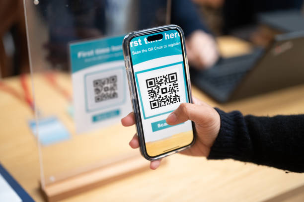 istock Seamless Entry: Asian Businesswoman Registers via Smartphone QR Code at Conference Check-In 1799771376