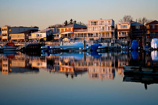 istock Reflection of coastline buildings in a calm bay 179979484