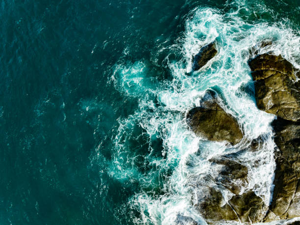 istock Bird eye view seashore with big wave crashing on rock cliff. Beautiful waves sea surface in sunny day summer background, Amazing seascape top view seacoast landscape view 1799818778