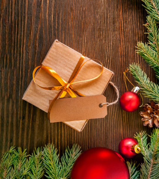 istock Christmas tree with gift box and decorations on wooden background 1799841346