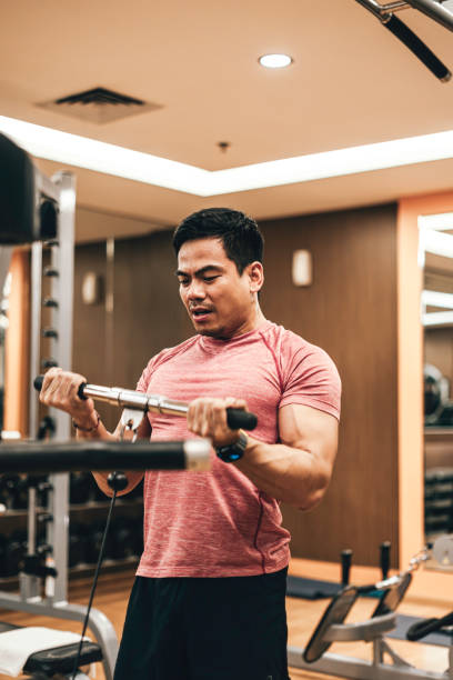 istock young man working out on rowing machine in gym 1799855313
