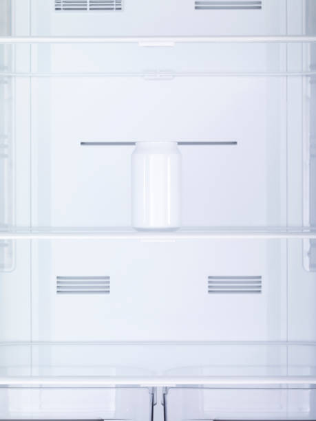istock White painted drink metal can on empty refrigerator shelf. No people. 1799857380