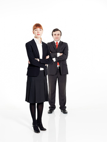 Successful, proud and happy business people standing on white background. Businesswoman and businessman. With suit. Two people.