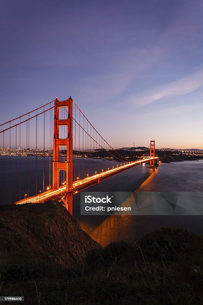 Golden Gate Bridge riflesso illuminato sullo skyline della città al tramonto - Foto stock royalty-free di Acqua