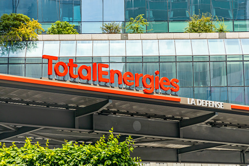 Total Energies logo on top of the gas station in La Defense district in Paris, France