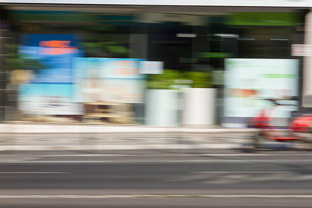 A city street with storefronts in panning effect