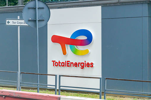 Total Energies logo at the entrance of a gas station in Paris, France