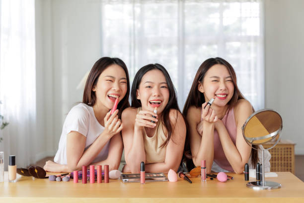 istock Three Asian Woman friends share a light hearted moment applying makeup 1799897940