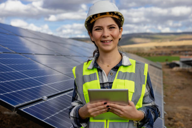 istock Female engineer working on a digital tablet behind solar panels 1799912554