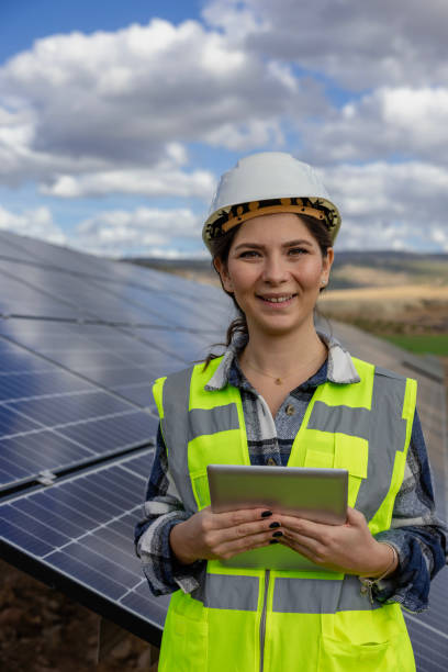 istock Female engineer working on a digital tablet behind solar panels 1799912560
