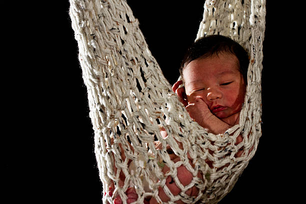 istock Newborn Baby sleeping in a Hammock hanging from tree 179992563