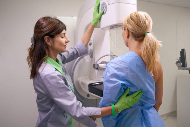 istock Professional radiographer preparing client for diagnostic mammogram 1799926167