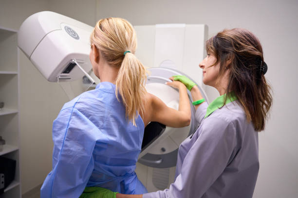 istock Radiographer preparing female client for digital breast tomosynthesis 1799926171