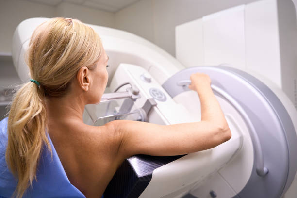 Adult female patient receiving 3D mammography in clinic stock photo