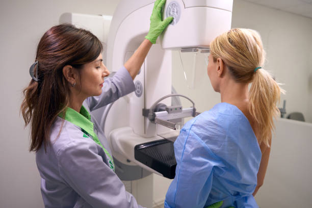 istock Qualified mammographer preparing woman for screening mammogram 1799926189