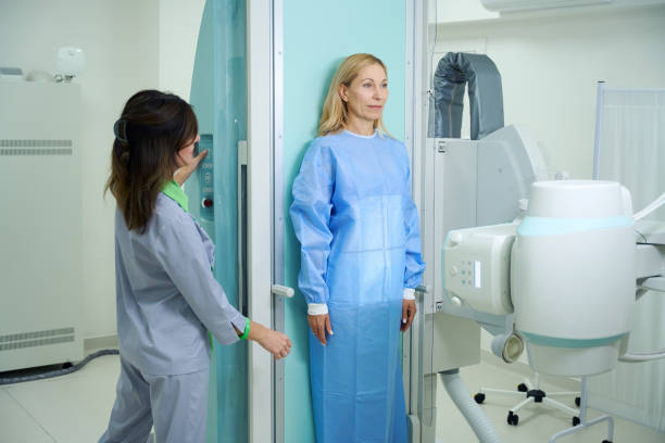 istock Qualified radiologic technologist preparing lady for radiography 1799926805