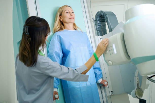 istock Experienced radiologic technologist preparing female patient for radiography 1799926807