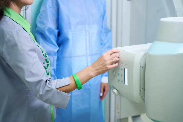 istock Qualified radiologic technologist preparing patient for radiographic examination 1799926815