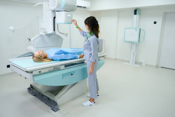 istock Qualified radiologic technologist preparing woman for radiography 1799926819