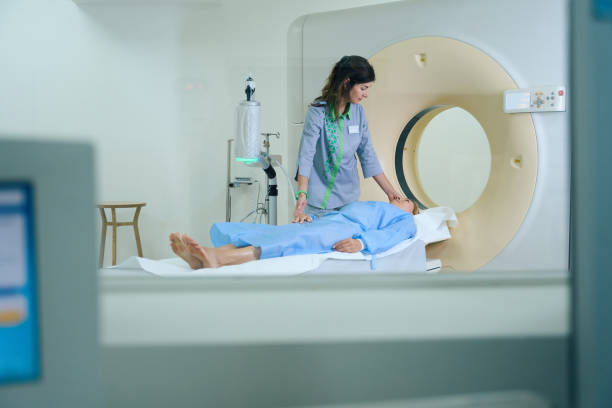 istock Qualified radiographer is getting patient ready for computed tomography 1799927388