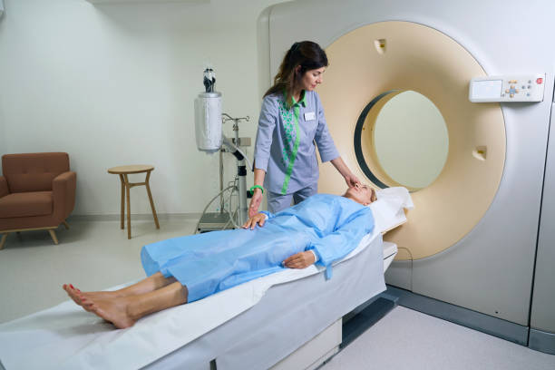 istock Radiologic technologist is preparing adult woman for computed tomography 1799927405