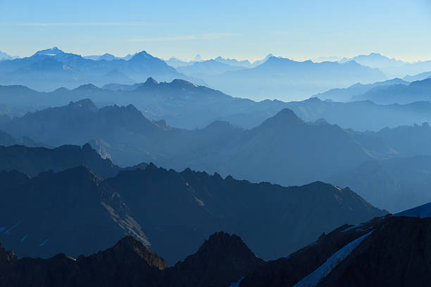 Blue layers of mountains Stunning panorama in the Alps with a majestic view on the high peaks of the Ecrins Massif National Park, France. distant stock pictures, royalty-free photos & images