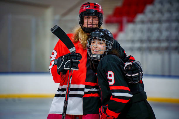 ice hockey players pose with hugs