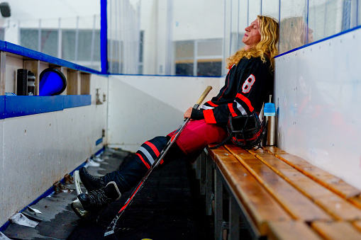 Ice hockey player sitting on a bench